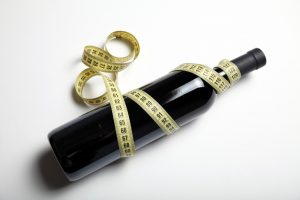 bottle of wine wrapped in measuring tape